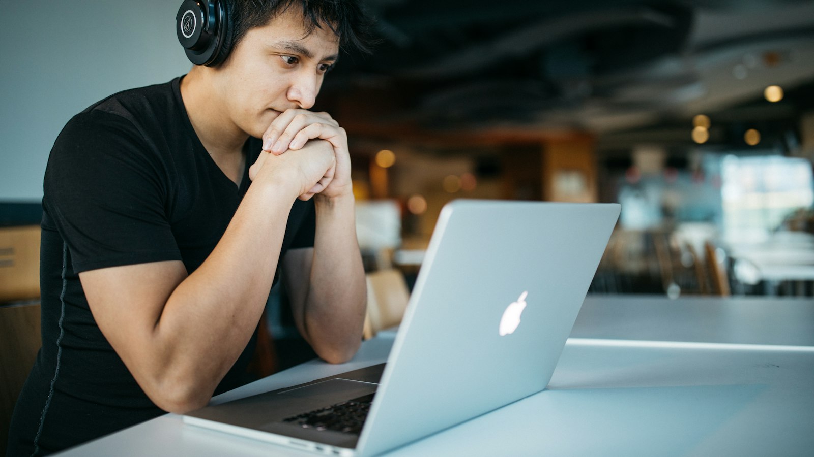 Student with headphones learning on a laptop