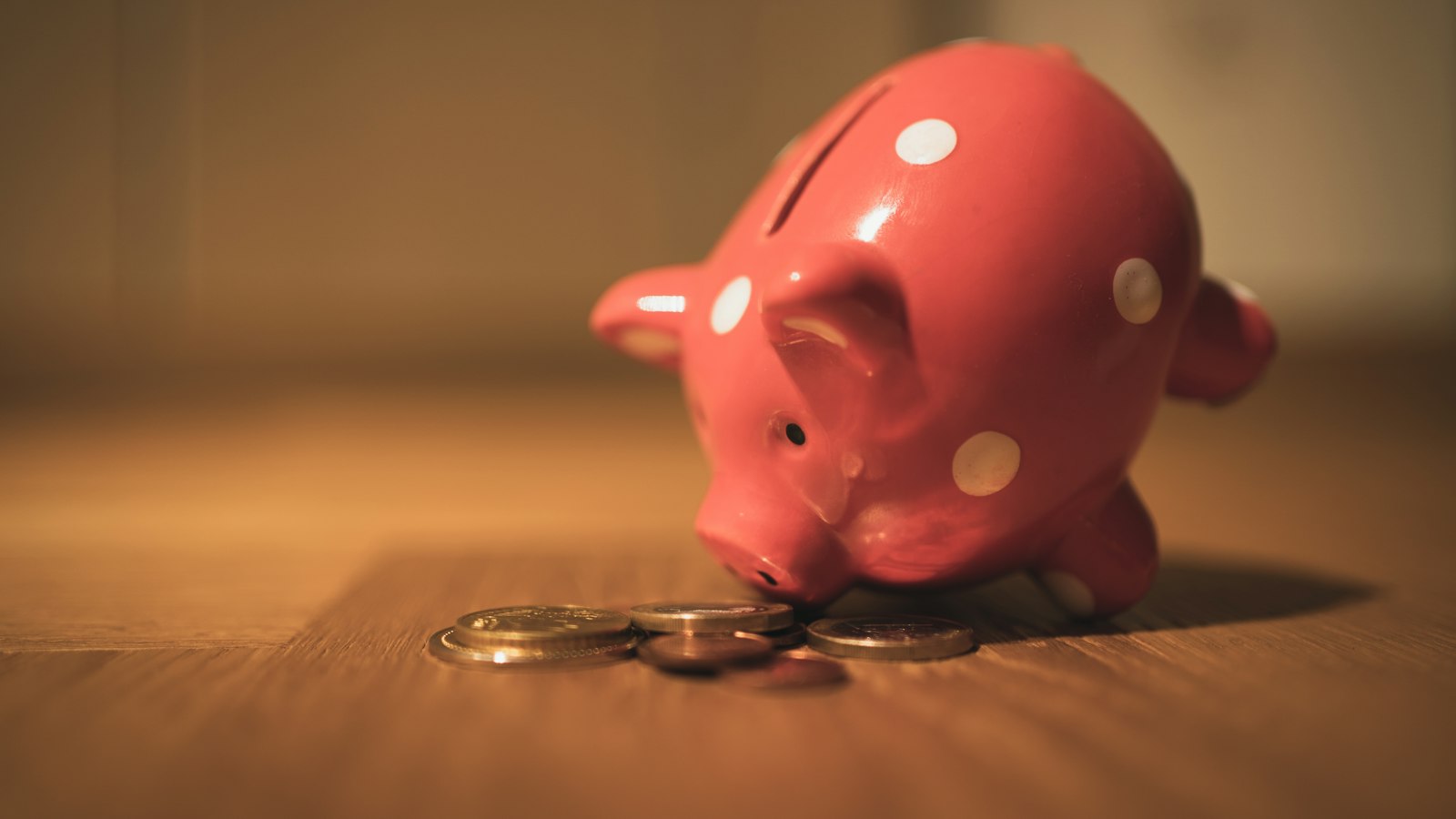Pink piggy bank on a wooden table