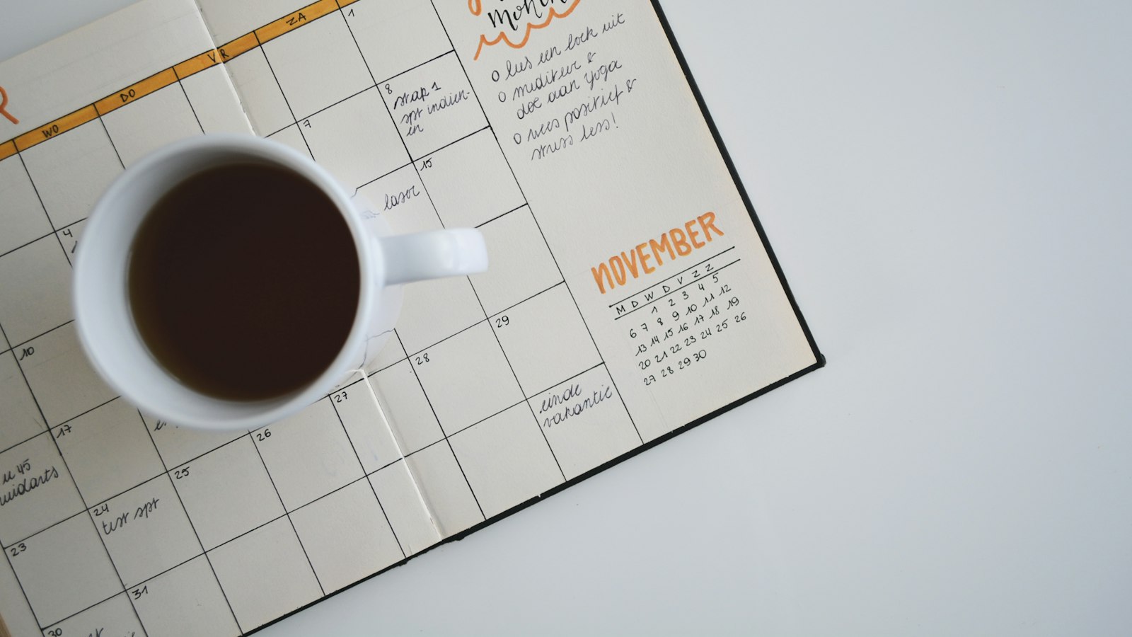 Coffee mug on top of a weekly planner